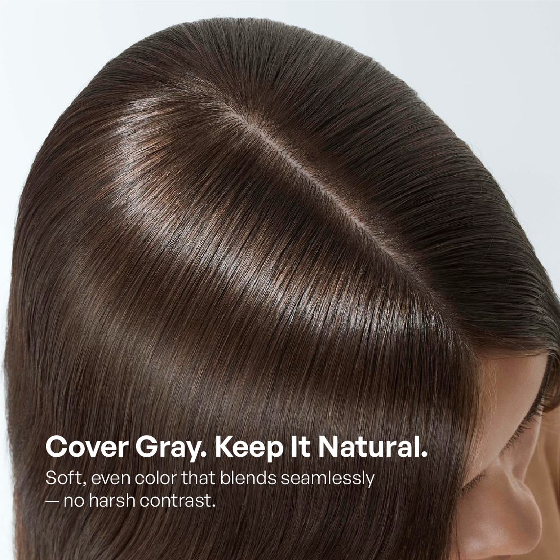 Close-up of brown hair part showing natural-looking gray coverage with seamless, even hair color blend