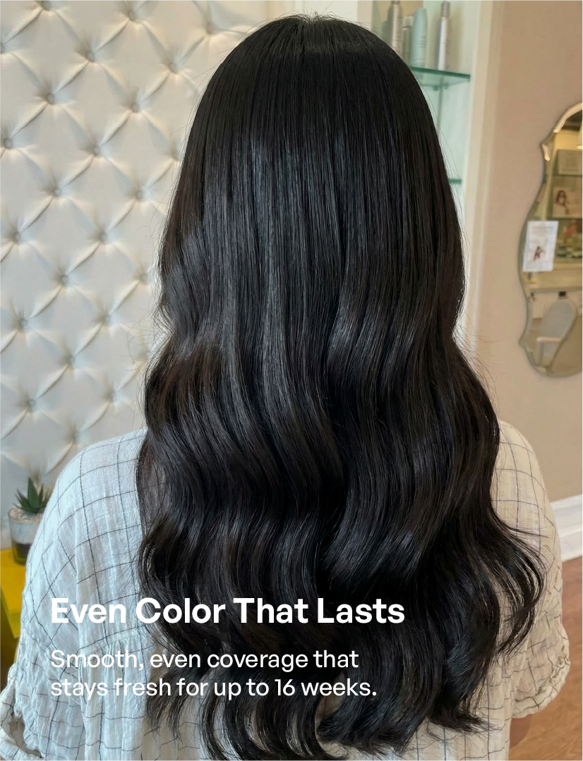 Close-up of radiant, high-shine black hair showing professional salon-quality results. Featuring even color distribution and fade-resistant formula for a vibrant look that lasts 16 weeks.